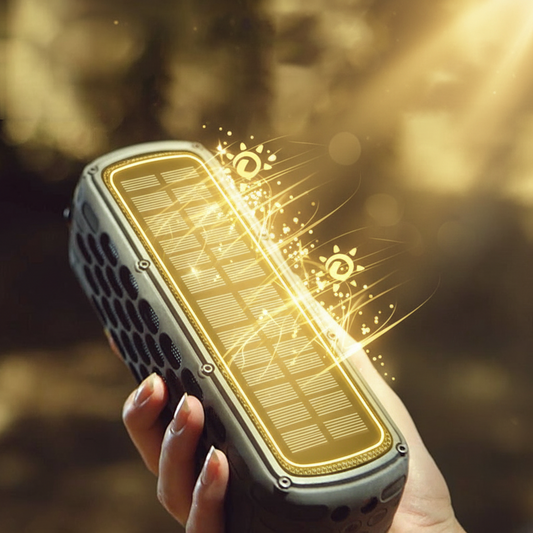 Hand holding a rectangular black and yellow speaker against a blurred natural background